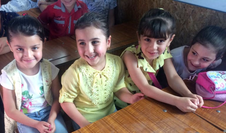 Neljä nauravaa tyttöä koulussa Lähi-idässä