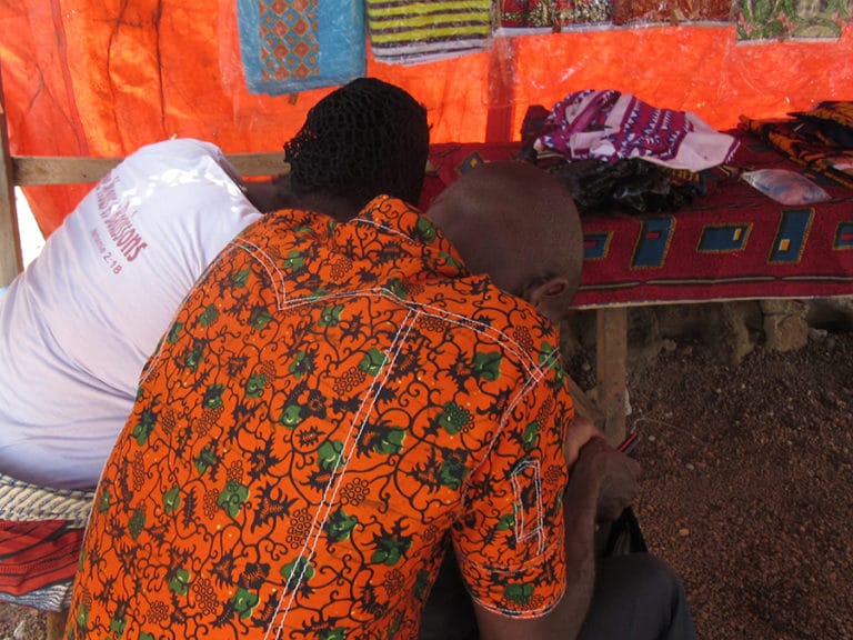 Kristityt mies ja nainen Norsunluurannikolta rukoilemassa