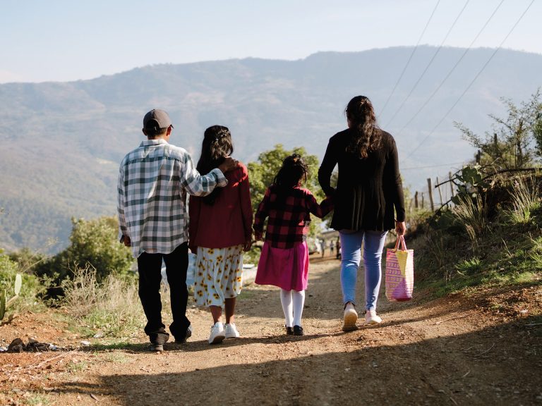 A mexican christian family walking along a road
