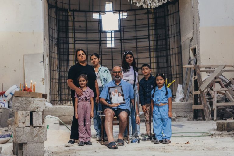 Perhe pommi-iskussa vaurioituneessa kirkossa.