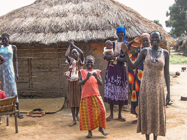 Etelä-sudanilaisia kotinsa edessä